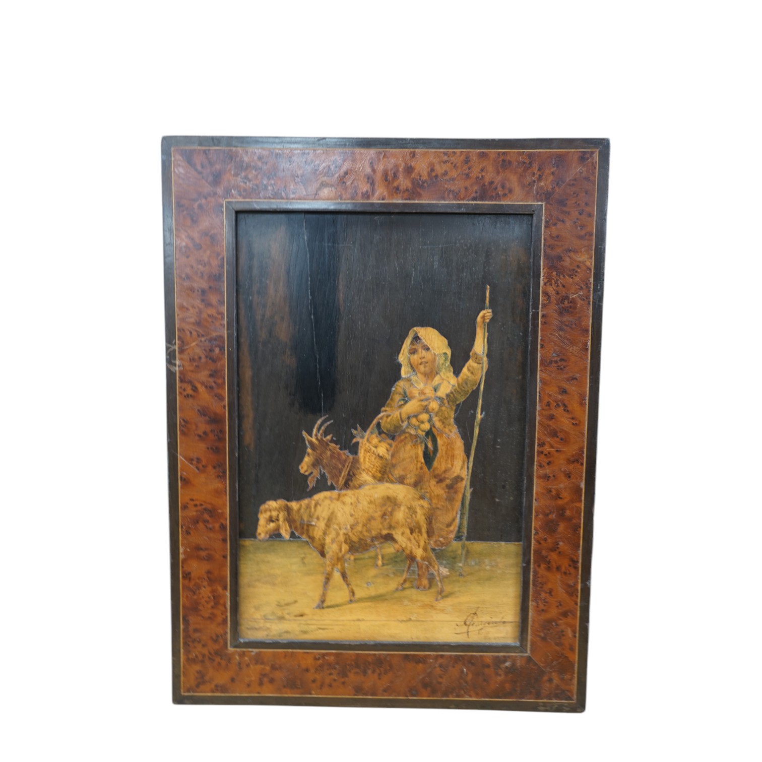 An Italian burr walnut framed, parquetry panel of a girl carrying a basket of fruit surrounded by a goat and sheep, signed. 14cm wide, 36.5cm high excl. frame. Condition - worn in places